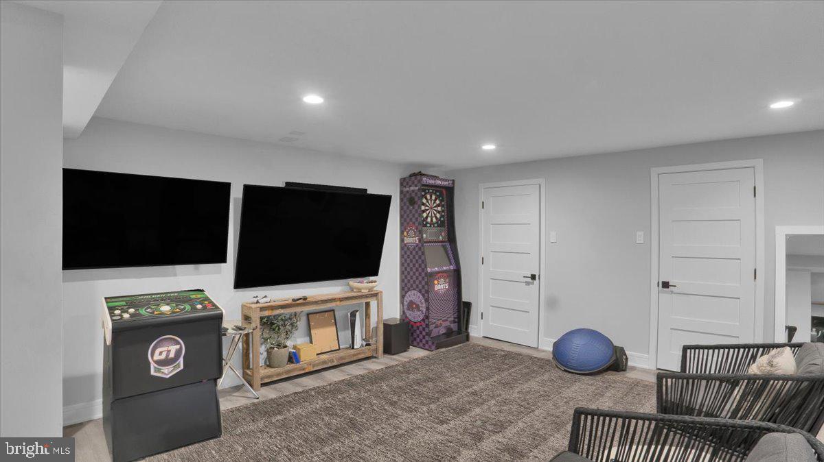 1433 Southwind Way Dresher, PA 19025 - Photo 27 of 37 a living room with a flat screen tv a rug a rug and a projector