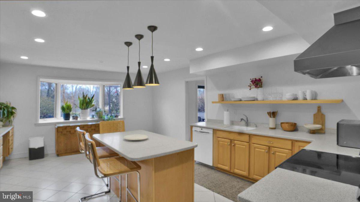 1433 Southwind Way Dresher, PA 19025 - Photo 9 of 37 a kitchen with a stove a refrigerator and a dining table with wooden floor