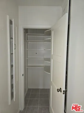 a room with a stove and a refrigerator