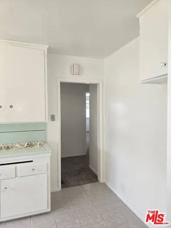 a kitchen with a sink and chandelier