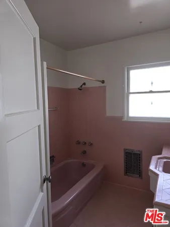 a white toilet sitting next to a shower curtain