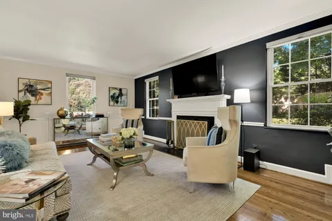 a living room with furniture and a painting on the wall