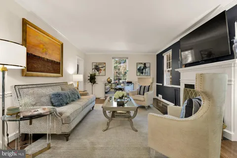 a living room with furniture and large windows