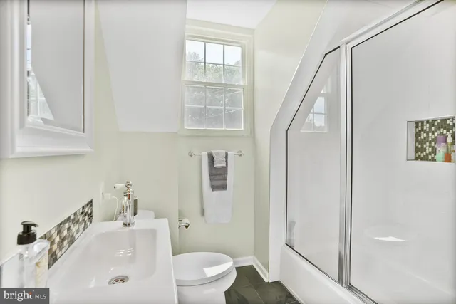 a bedroom with a bed window and a flat screen tv