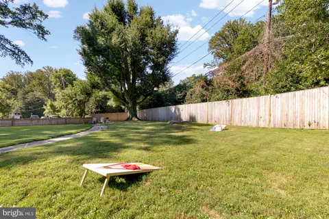 a view of patio with couches table and chairs and potted plants
