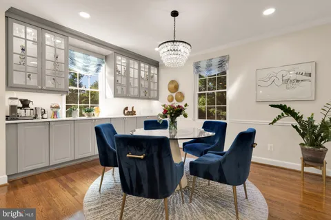 a view of a dining room with furniture wooden floor and chandelier