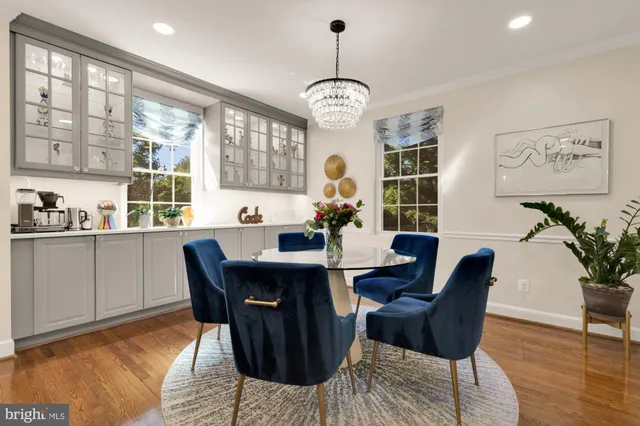 a view of a dining room with furniture wooden floor and chandelier