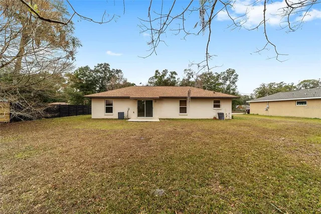a view of house with outdoor space and swimming pool