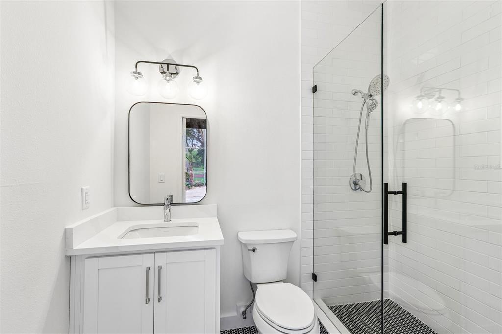 1012 Morfield Lane Brandon, FL 33511 - Photo 73 of 100 a bathroom with a sink a toilet and shower