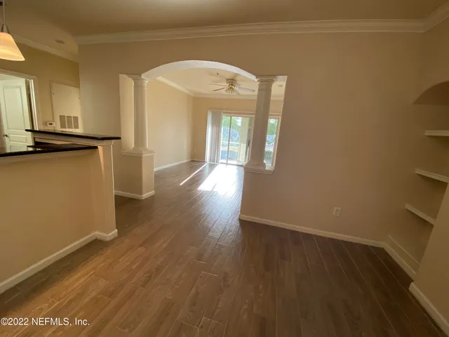 a view of a hallway with wooden floor
