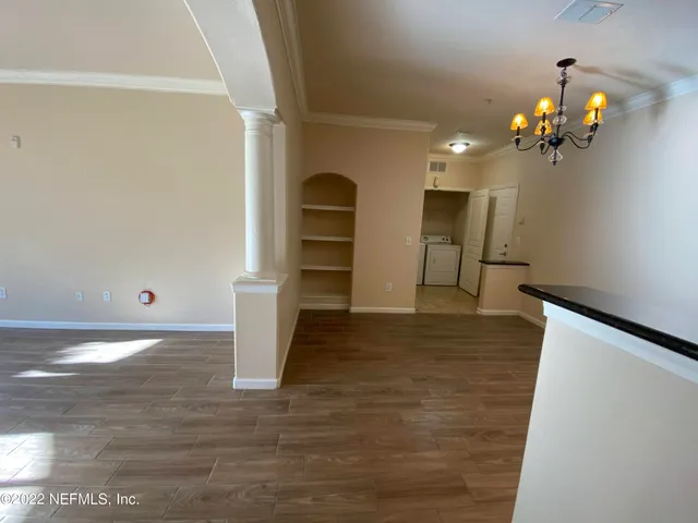 a view of a room with a fireplace and chandelier