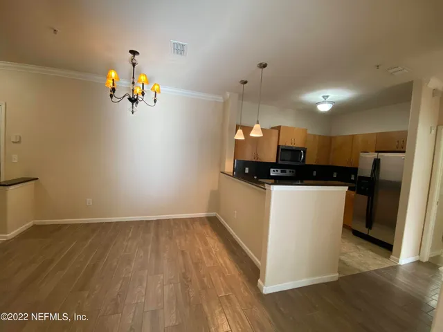 a view of a kitchen with a sink and a refrigerator