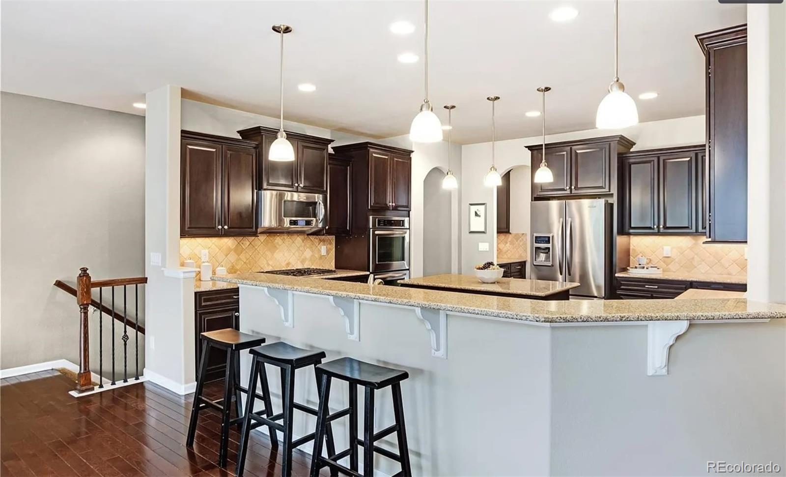 27235 East Lakeview Place Aurora, CO 80016 - Photo 11 of 22 a large kitchen with a table and chairs in it