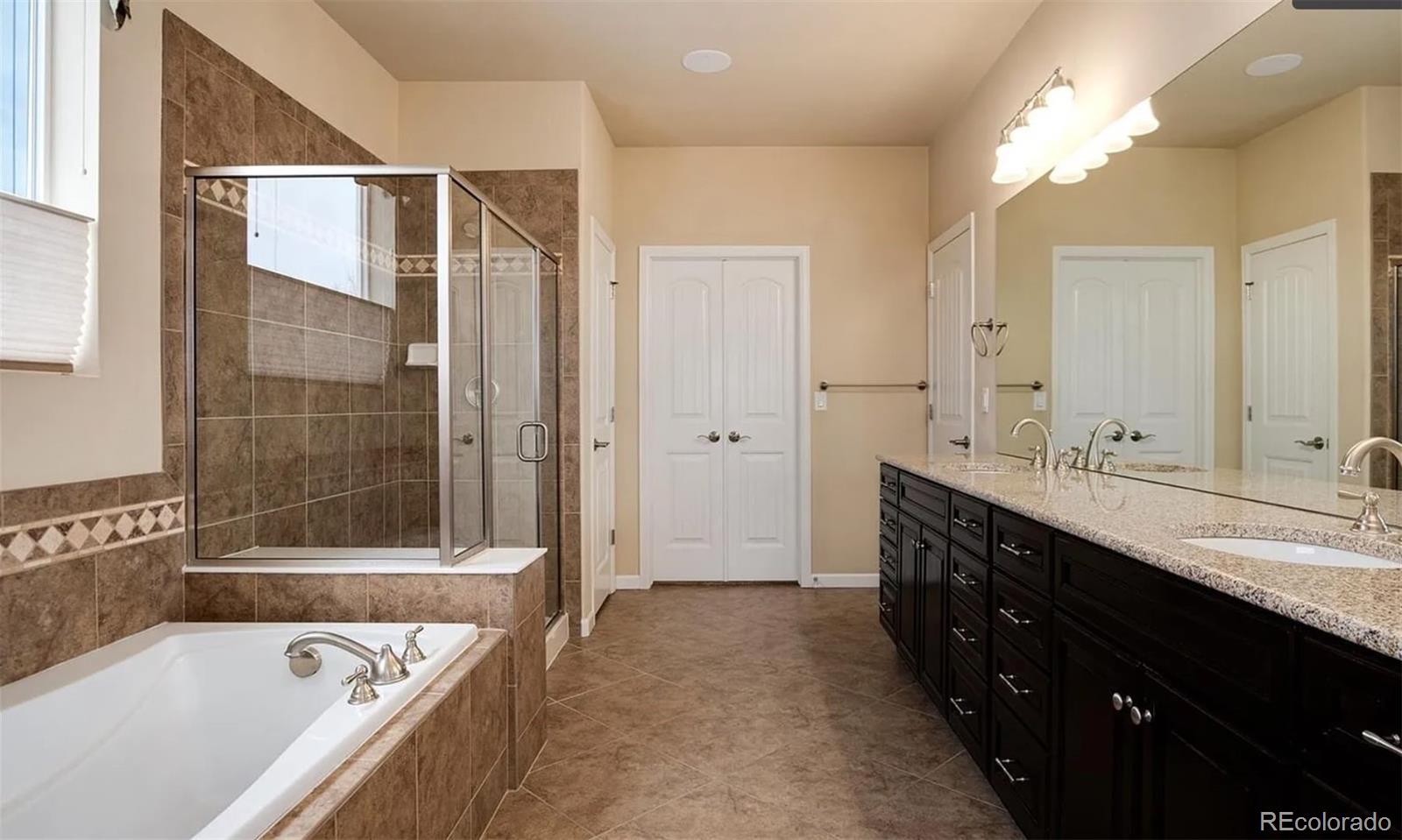 27235 East Lakeview Place Aurora, CO 80016 - Photo 15 of 22 a bathroom with a bathtub and a sink