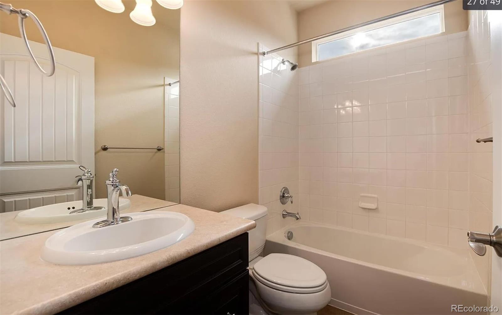 27235 East Lakeview Place Aurora, CO 80016 - Photo 17 of 22 a bathroom with a sink a toilet and shower