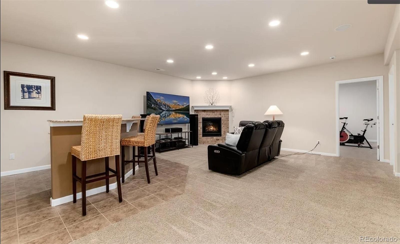 27235 East Lakeview Place Aurora, CO 80016 - Photo 19 of 22 a living room with furniture and a flat screen tv