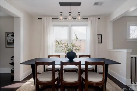 a view of a dining room with furniture and window