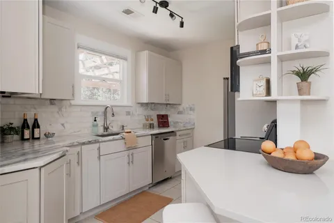a kitchen with stainless steel appliances a white cabinets and a sink