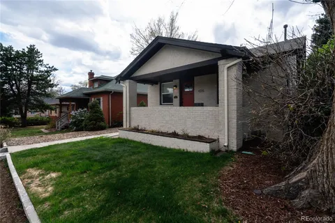 a view of house with backyard
