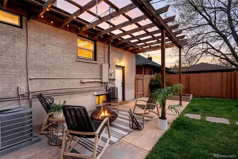 a view of a patio with table and chairs and potted plants