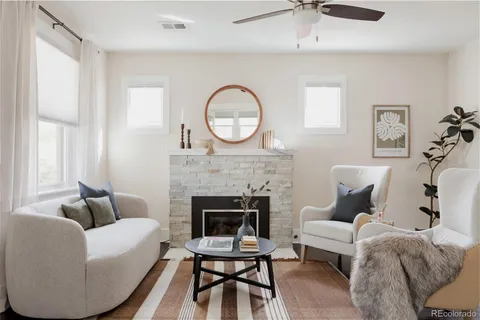 a living room with furniture and a fireplace