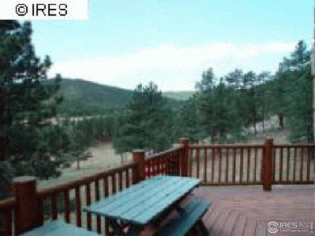 1075 Stove Prairie Road Bellvue, CO 80512 - Photo 4 of 8 a view of a wooden roof deck