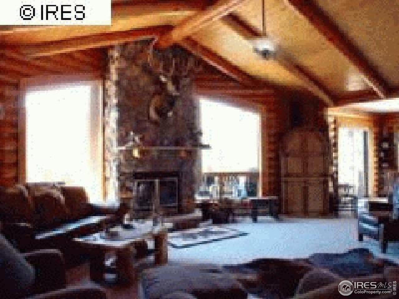 1075 Stove Prairie Road Bellvue, CO 80512 - Photo 6 of 8 a living room with furniture and a fireplace