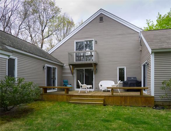 6 Steepletree Lane, Unit 6 Wayland, MA 01778 - Photo 14 of 16 a front view of house with yard and outdoor seating