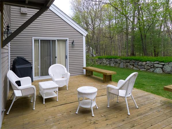 6 Steepletree Lane, Unit 6 Wayland, MA 01778 - Photo 15 of 16 a view of a chairs and table in backyard of the house