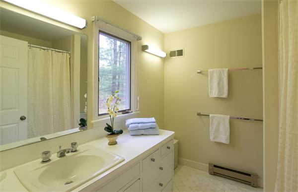 6 Steepletree Lane, Unit 6 Wayland, MA 01778 - Photo 8 of 16 a bathroom with a sink a mirror and a shower