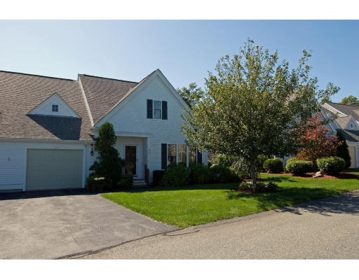 26 Stratford Ridge, Unit 26 Mashpee, MA 02649 - Photo 1 of 1 a front view of a house with a yard and garage