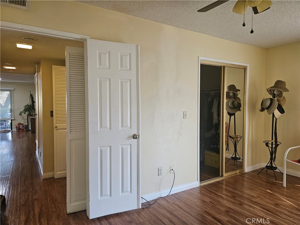3155 Ramon Road, Unit 601 Palm Springs, CA 92264 - Photo 19 of 35 a view of a hallway with closet and wooden floor