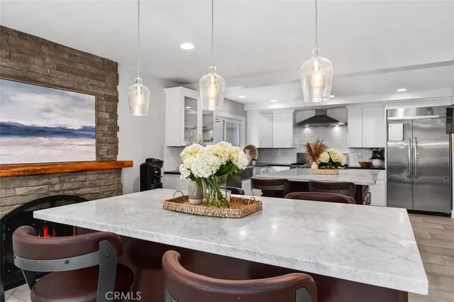 a kitchen with granite countertop a sink cabinets and stainless steel appliances
