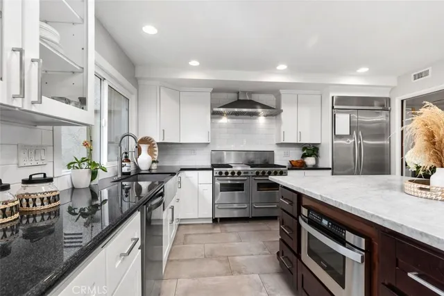 a spacious bedroom with a bed and a flat screen tv