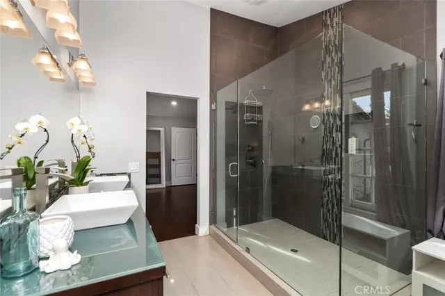 a bathroom with a double vanity sink toilet and shower