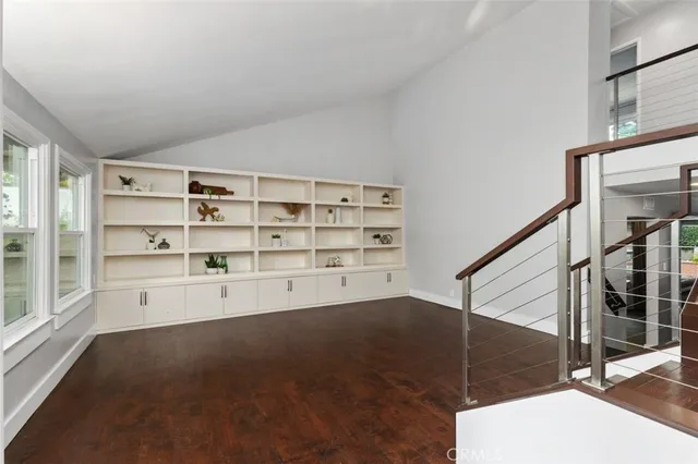 a living room with furniture and stairs
