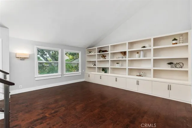 a living room with furniture and large windows