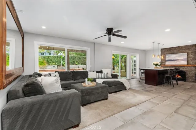 a living room with couches and kitchen view