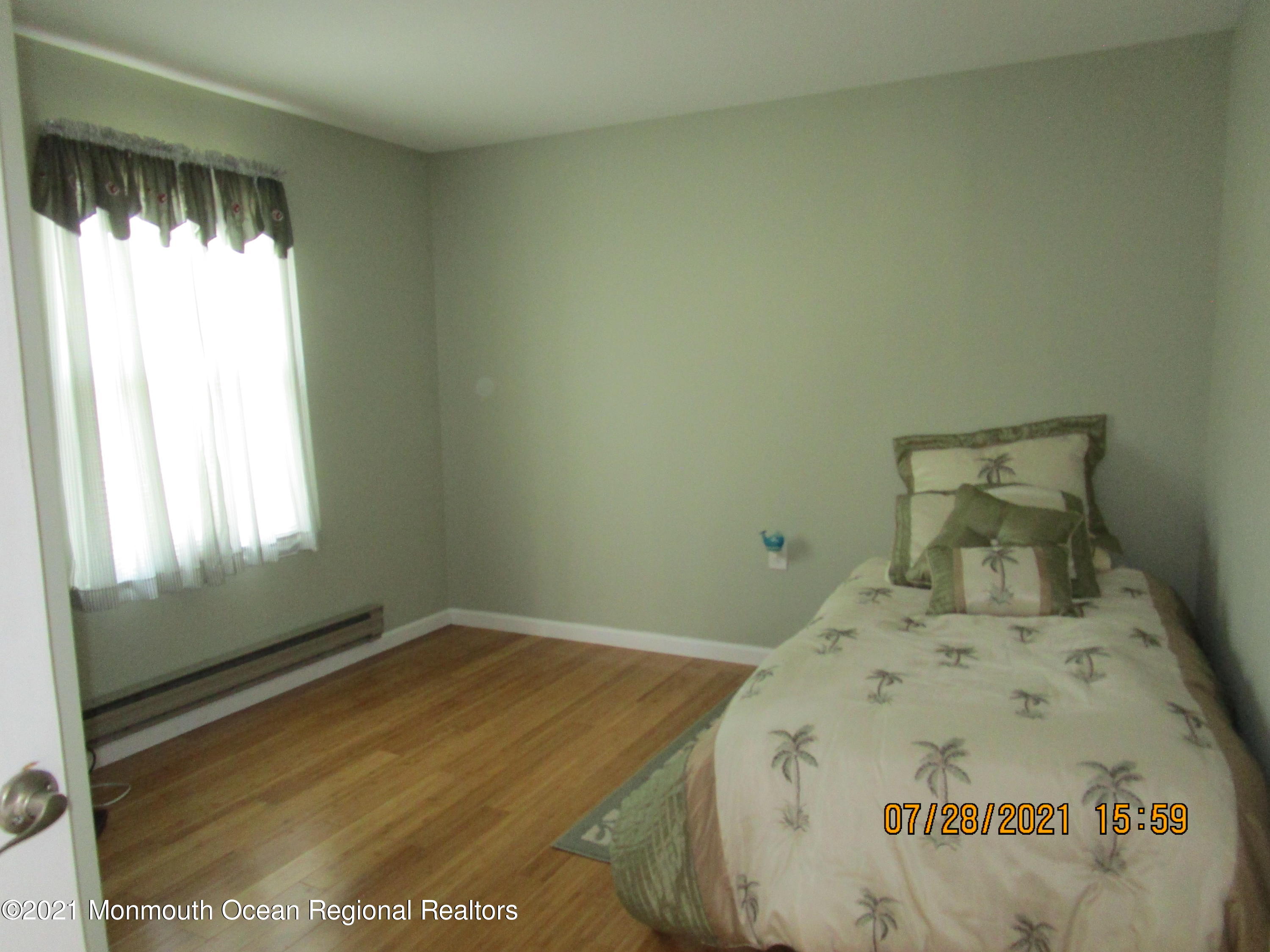 16 D Ashley Road Whiting, NJ 08759 - Photo 11 of 15 a bed sitting in a bedroom next to a window
