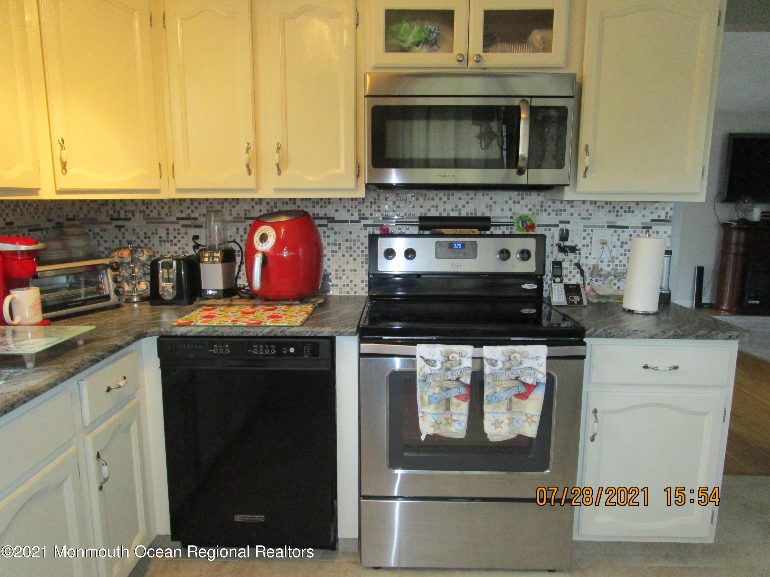 16 D Ashley Road Whiting, NJ 08759 - Photo 6 of 15 a kitchen with stainless steel appliances granite countertop a stove and a microwave