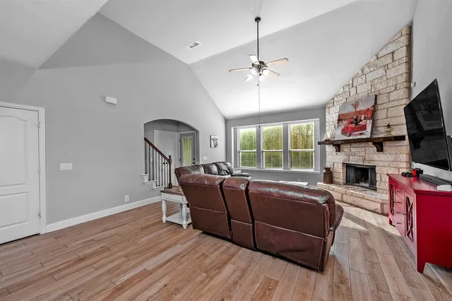 a living room with furniture fireplace and flat screen tv