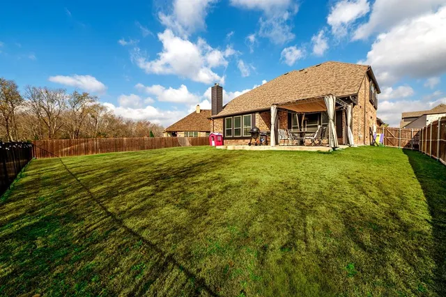 a view of a porch with chairs and backyard