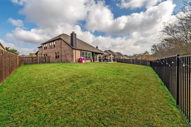 a view of a house with a yard and sitting area