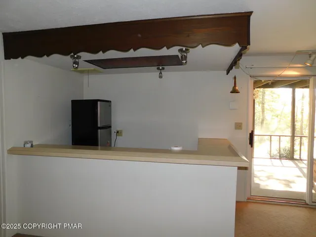 a view of empty room with cabinet and floor to ceiling window