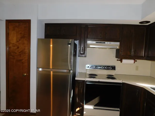 a refrigerator freezer sitting inside of a kitchen