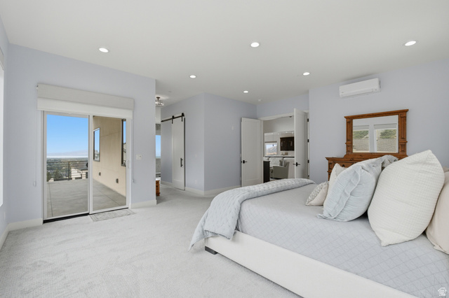 1445 Jacob Road Sandy, UT 84092 - Photo 21 of 52 Sliding glass door to an outdoor patio, recessed lighting, wall-mounted air conditioning unit, and a barn door entry