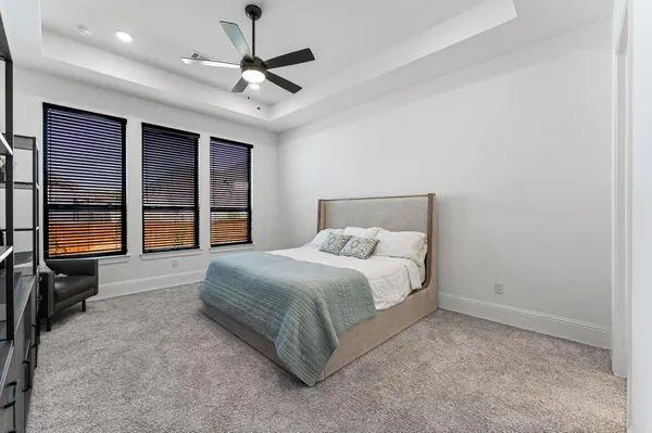 a bedroom with a bed and a large window