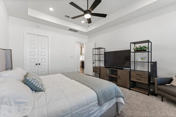 a bedroom with a bed and a flat screen tv