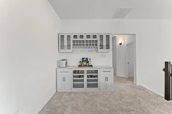 a view of kitchen with stainless steel appliances cabinets and window