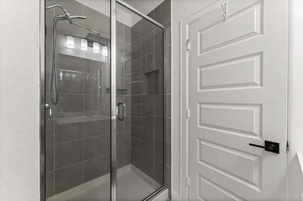a bathroom with a glass shower door